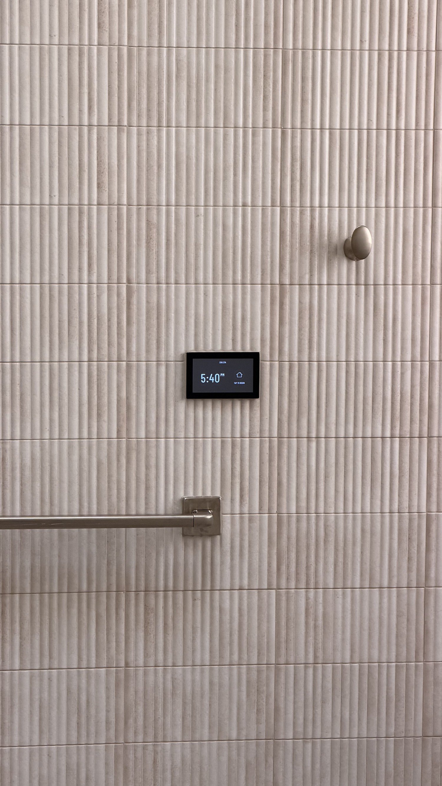 Fluted shower wall with a digital control and a grab bar